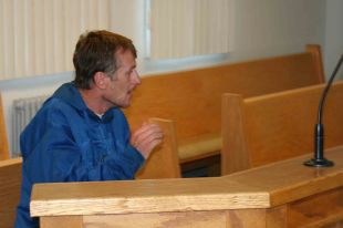 Brian Morris Benoit speaks with his defence counsel at Stephenville Provincial Court on Aug. 9.